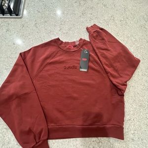 Levi’s cropped rust colored sweatshirt, size small. Brand new with tags on